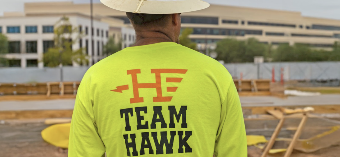 Someone in a hat wearing a Hawkeye Electric Shirt